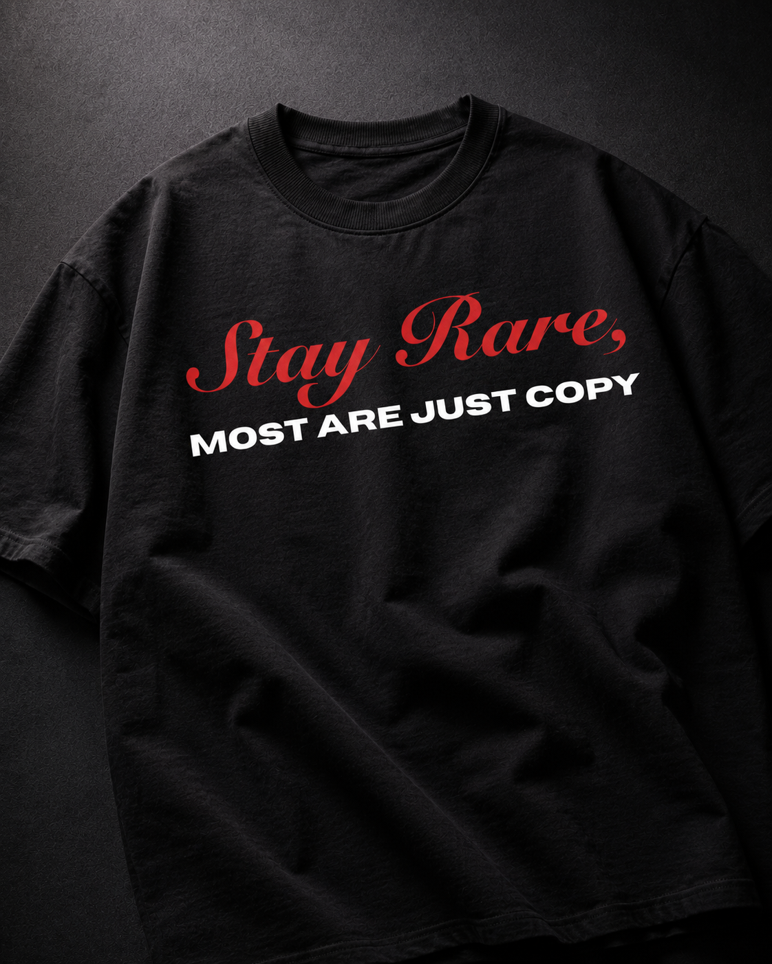 Genaura Stay Rare black oversized tee flat lay, red script graphic print