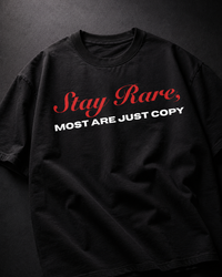 Genaura Stay Rare black oversized tee flat lay, red script graphic print
