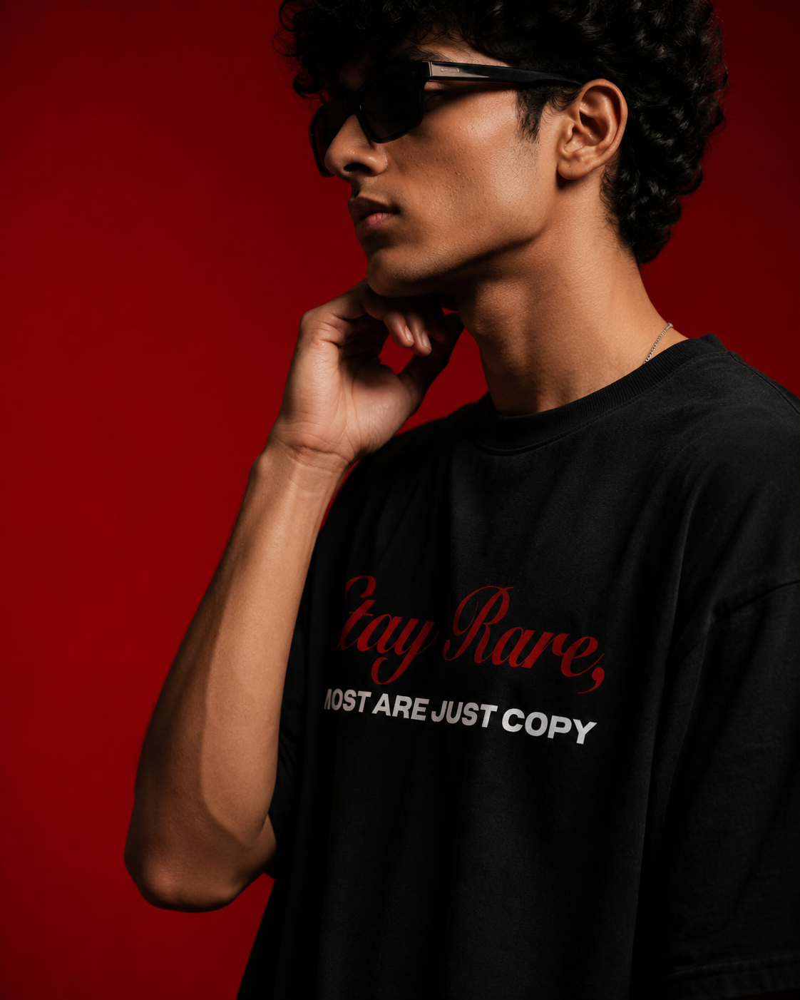 Model wearing Genaura Stay Rare oversized tee, red script graphic tee