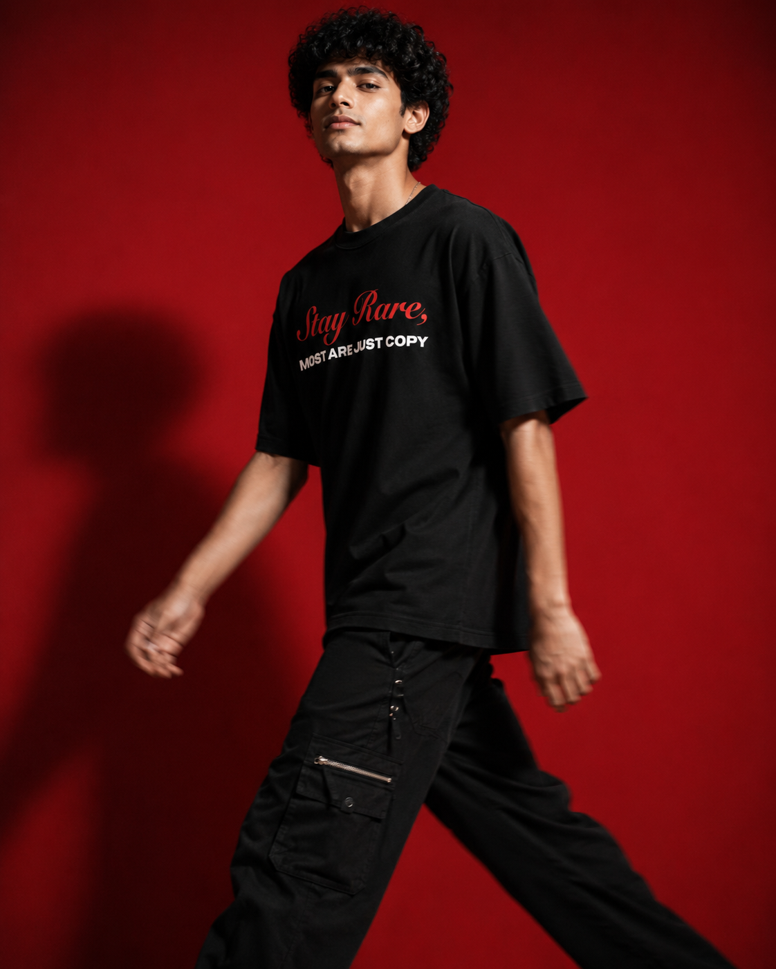 Genaura Stay Rare oversized tee, model walking, streetwear graphic tee India