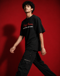 Genaura Stay Rare oversized tee, model walking, streetwear graphic tee India